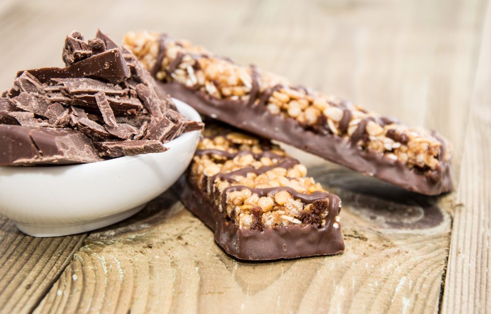 Muesli Bars with Chocolate in a bowl on wooden background